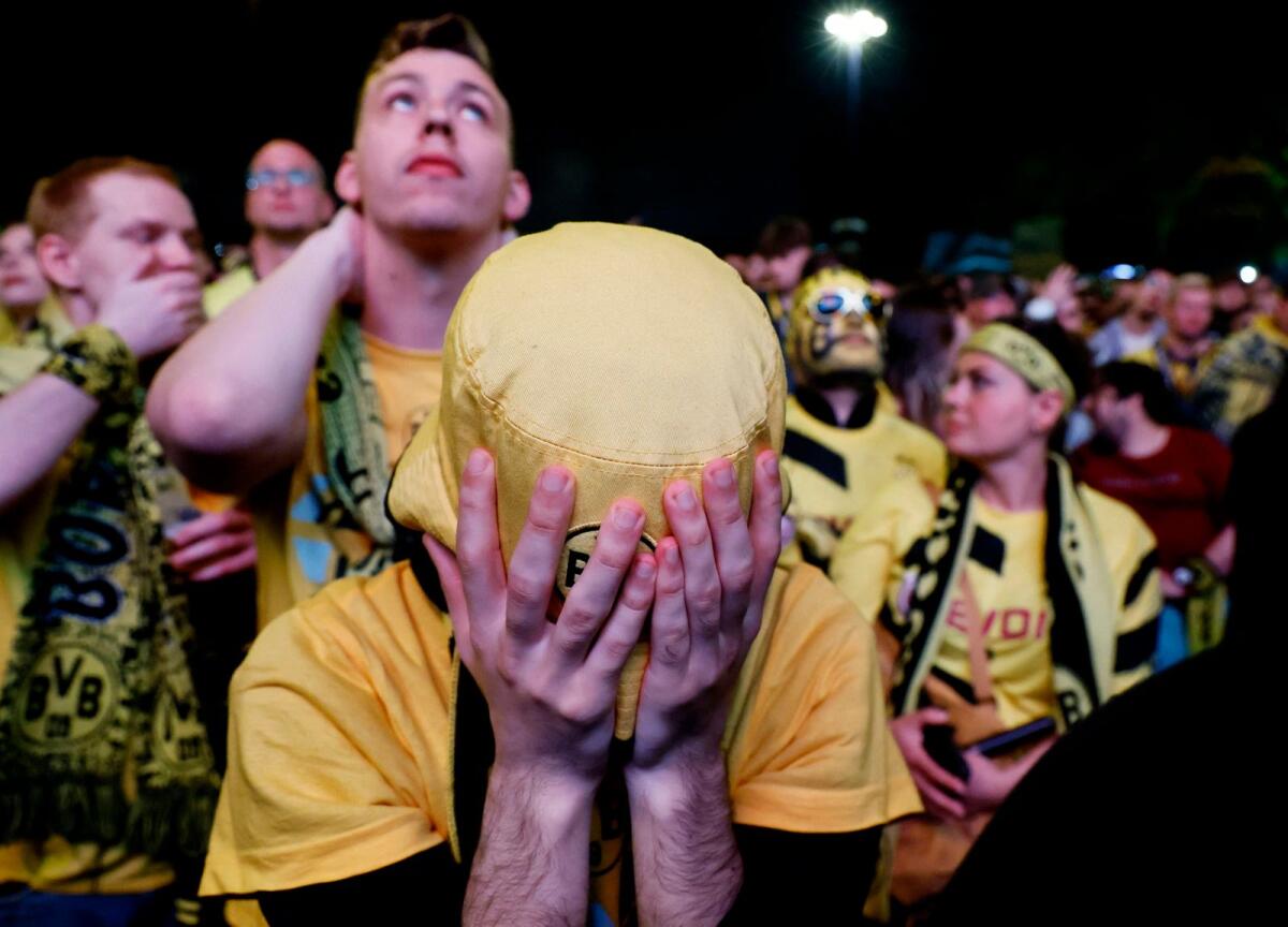 A Borussia Dortmund fan reacts after the team's defeat. — Reuters