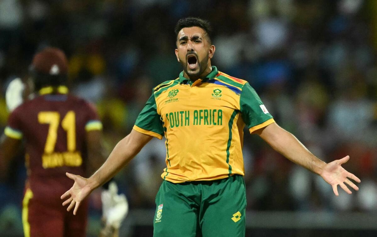 South Africa's Tabraiz Shamsi reacts after the dismissal of West Indies' Kyle Mayers (L). Photo: AFP