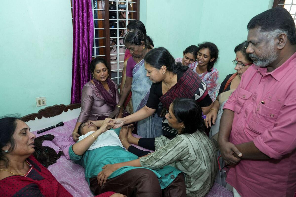 Veena George, Kerala's Minister for Health and Woman and Child Development, consoles the mother of Akash Sasidharan Nair, one of the victims of a fire that broke out in a building housing foreign workers in Kuwait, at Pathanamthitta district on Thursday. Photo: Reuters