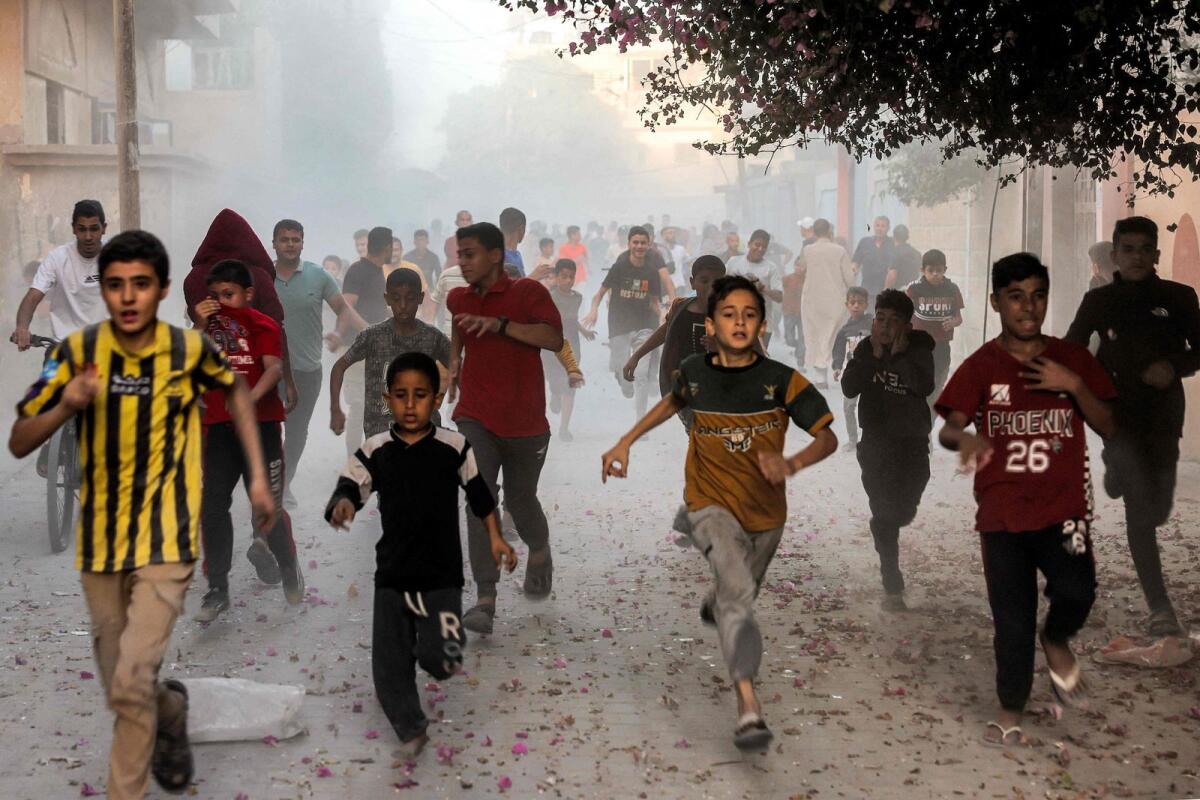 Palestinian children run as they flee from Israeli bombardment in Rafah in the southern Gaza Strip on November 6, 2023.  Photo: AFP
