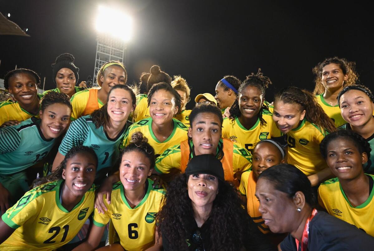 Cedella Marley (centre bottom) poses with Jamaica women's football team. — AFP file