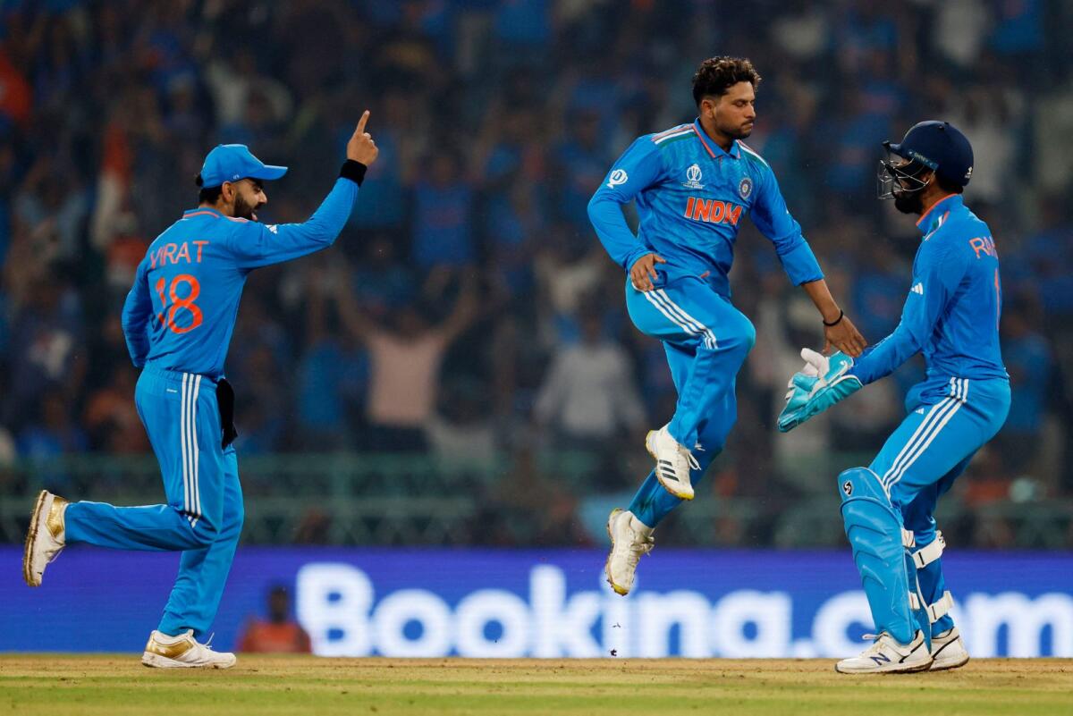 India's Kuldeep Yadav celebrates with KL Rahul and Virat Kohli after taking the lbw wicket of England's Liam Livingstone. Photo: Reuters