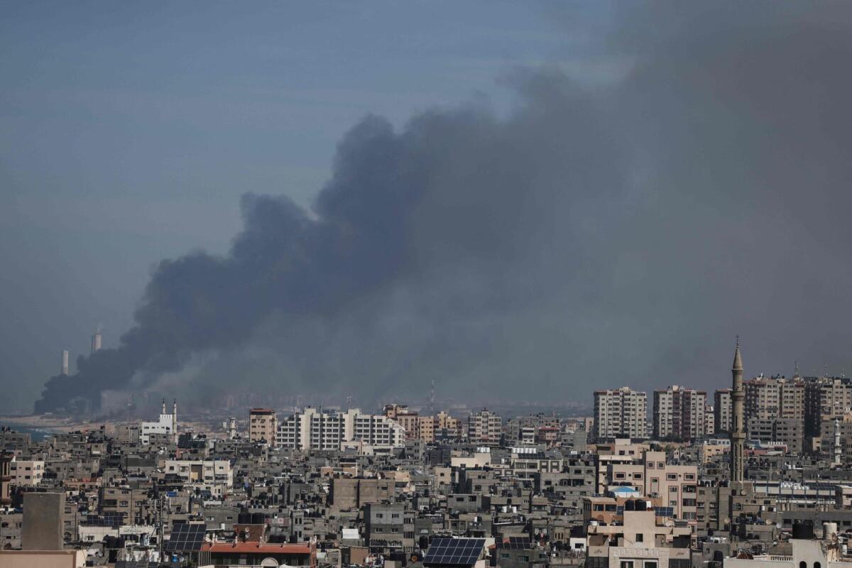 Smoke billows over the Israeli side of the border with Gaza as seen from Gaza City on October 7, 2023 following a series of early morning rocket attacks from the Gaza Strip into Israel. Photo: AFP