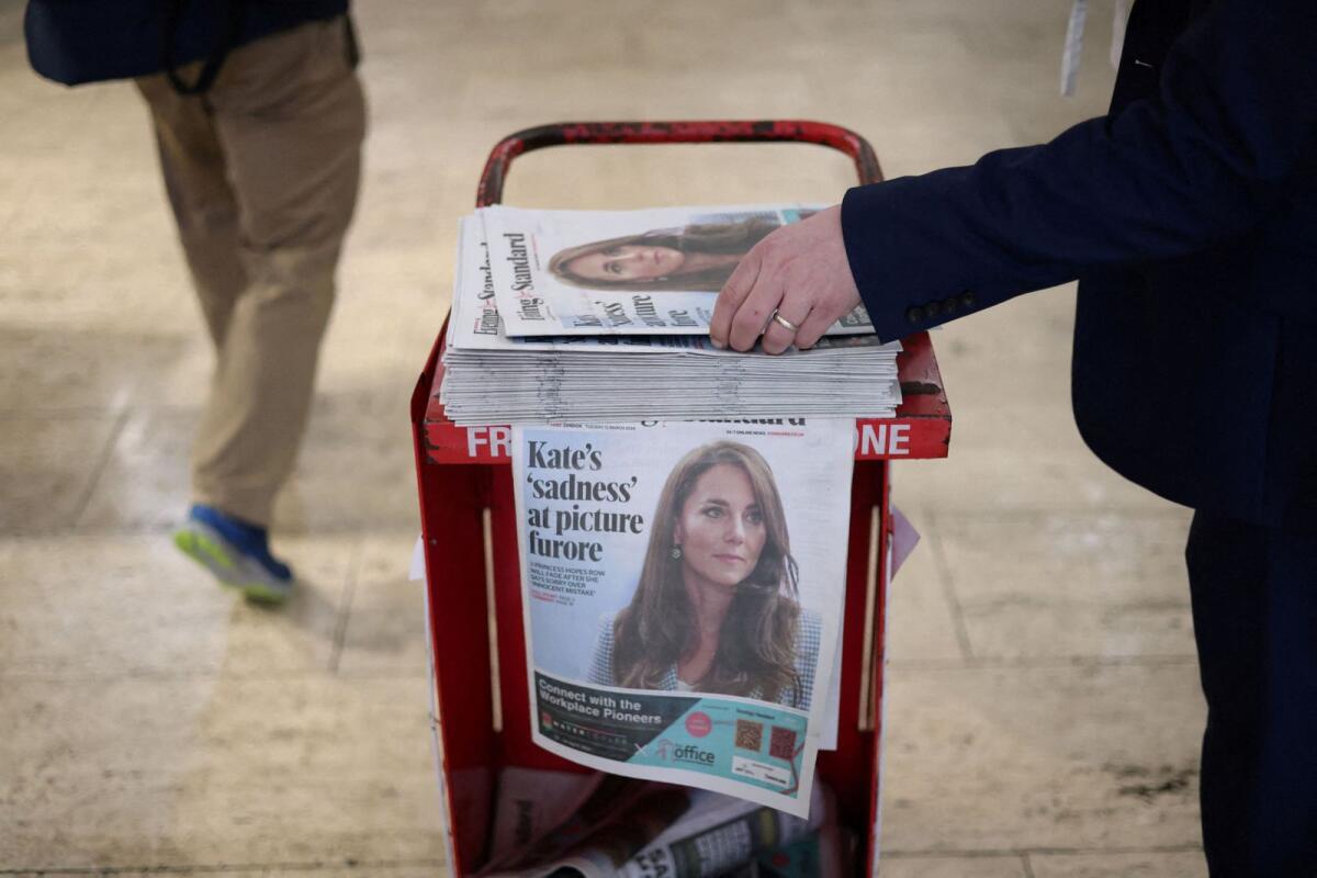 A commuter picks up a copy of the Evening Standard featuring a picture of Britain's Catherine, Princess of Wales, on the front page at subway station in London, Britain, March 12, 2024. — Reuters
