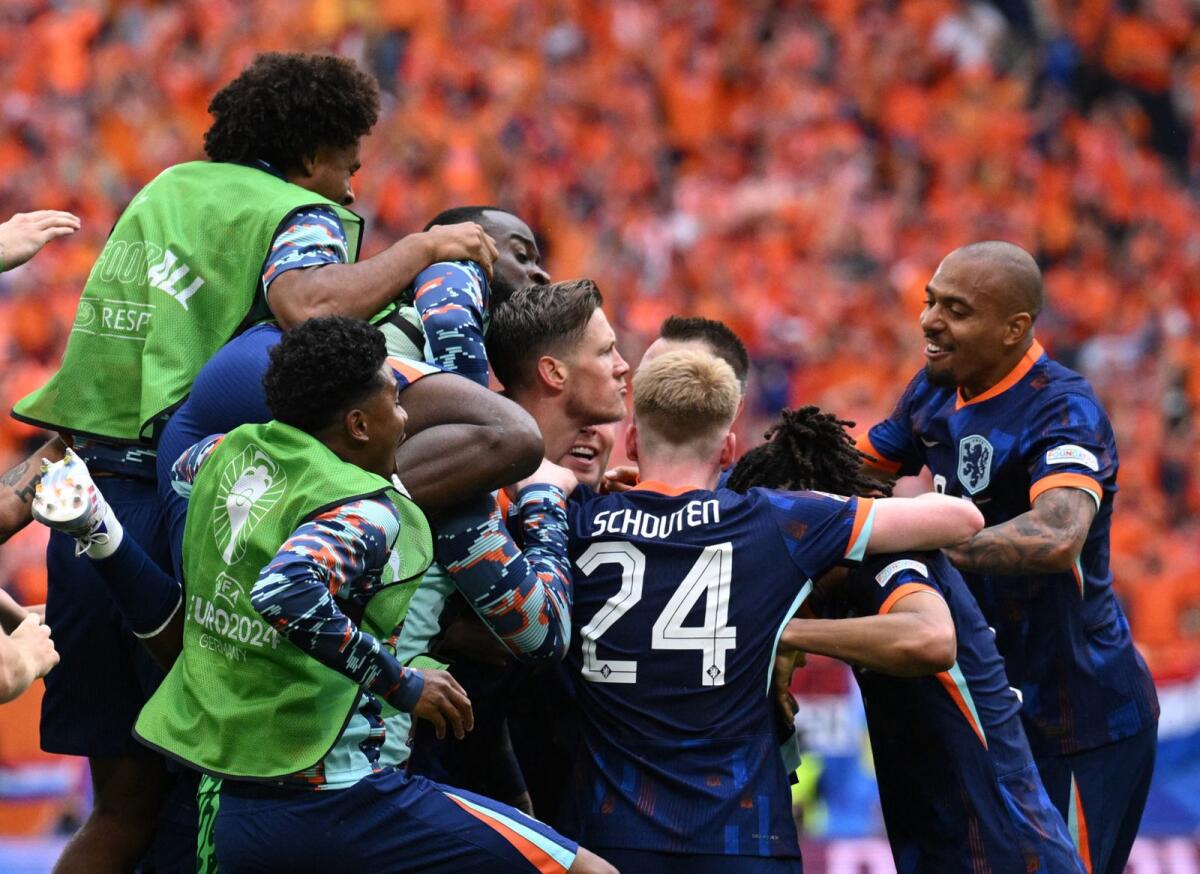 Netherlands' Wout Weghorst celebrates scoring their second goal with teammates. —  Reuters