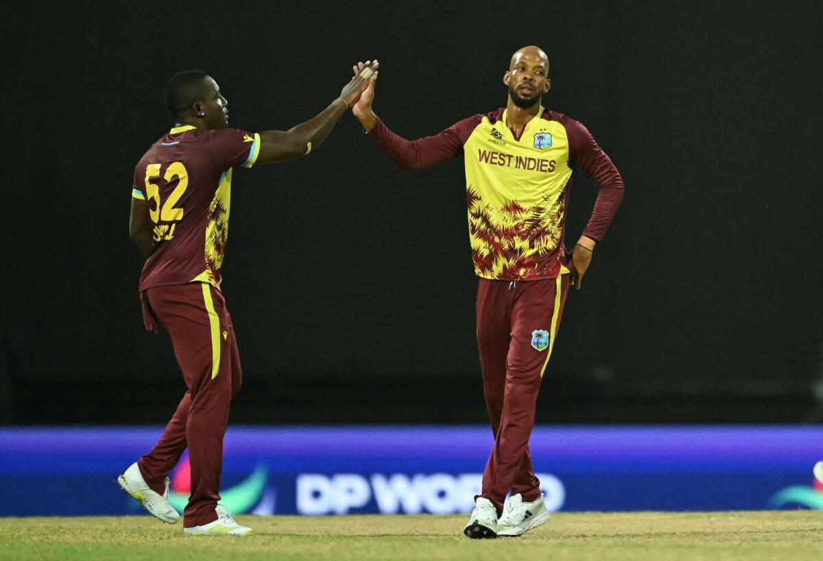 West Indies' Roston Chase (right) and captain Rovman Powell celebrate a wicket during the match against South Africa. — AFP