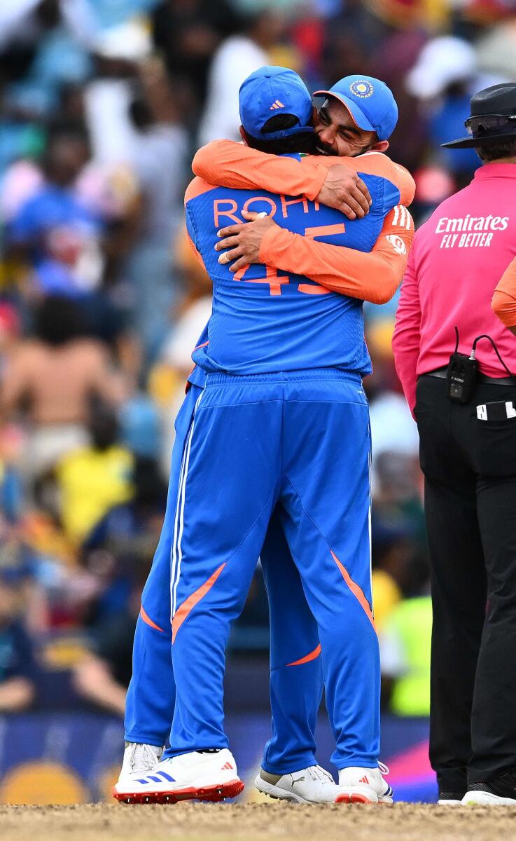 India's captain Rohit Sharma hugs Virat Kohli as they celebrate the win. — AFP
