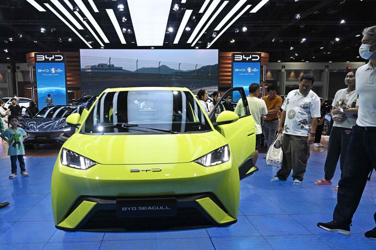 People look at a BYD Seagull car by Chinese electric vehicle (EV) manufacturer BYD at the Bangkok International Motor Show in Nonthaburi on March 27, 2024.  — AFP file