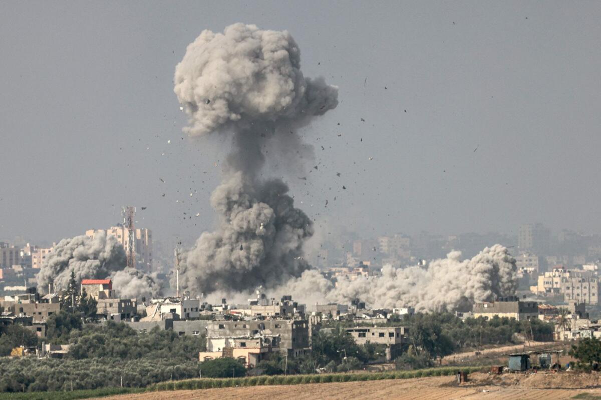 A picture taken from the southern Israeli city of Sderot on October 23, 2023, shows smoke and debris ascending over the northern Gaza Strip following an Israeli strike. Photo: AFP