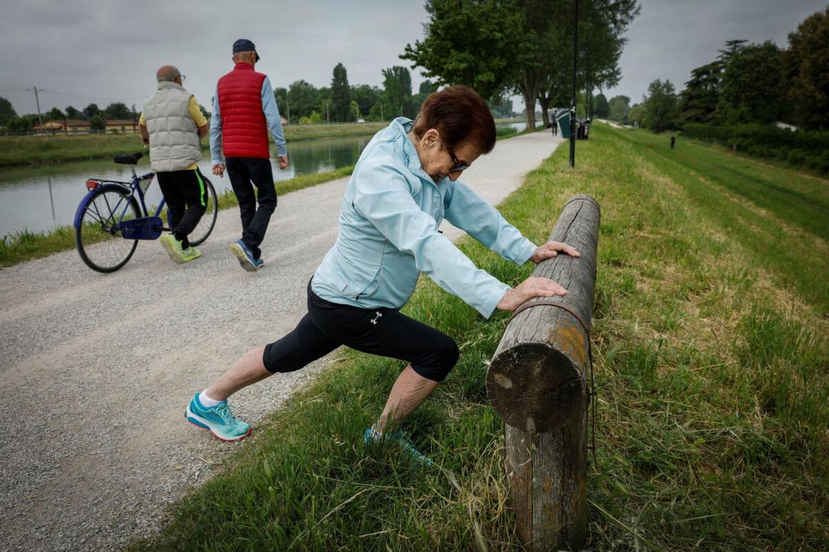 Italian master runner Emma Maria Mazzenga, 90, stretches before running, at a park in Padua, Italy, on May 6, 2024. — Reuters