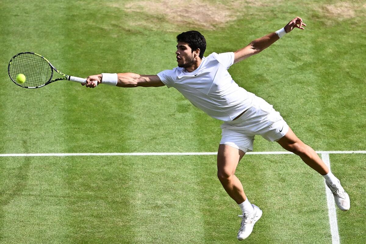 Spain's Carlos Alcaraz hits a return during the Wimbledon final last year against Serbia's Novak Djokovic. — AFP