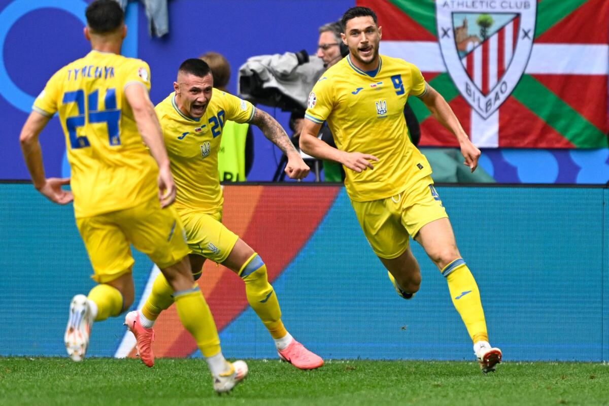 Ukraine's Roman Yaremchuk celebrates with teammates after scoring his team's second goal against Slovakia. — AFP