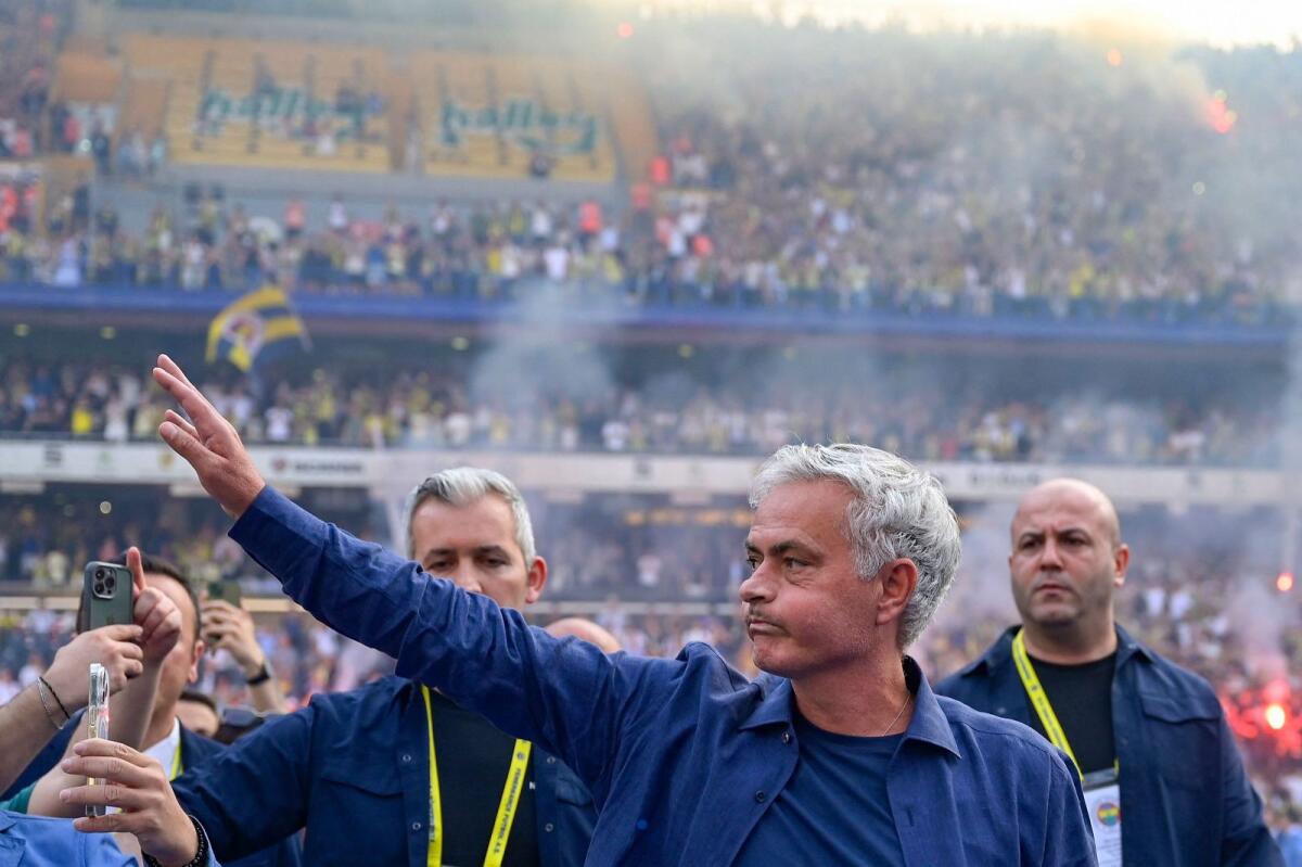 New Fenerbahce coach Jose Mourinho (centre) waves during the presentation at the Sukru Saracoglu Stadium in Istanbul. — AFP