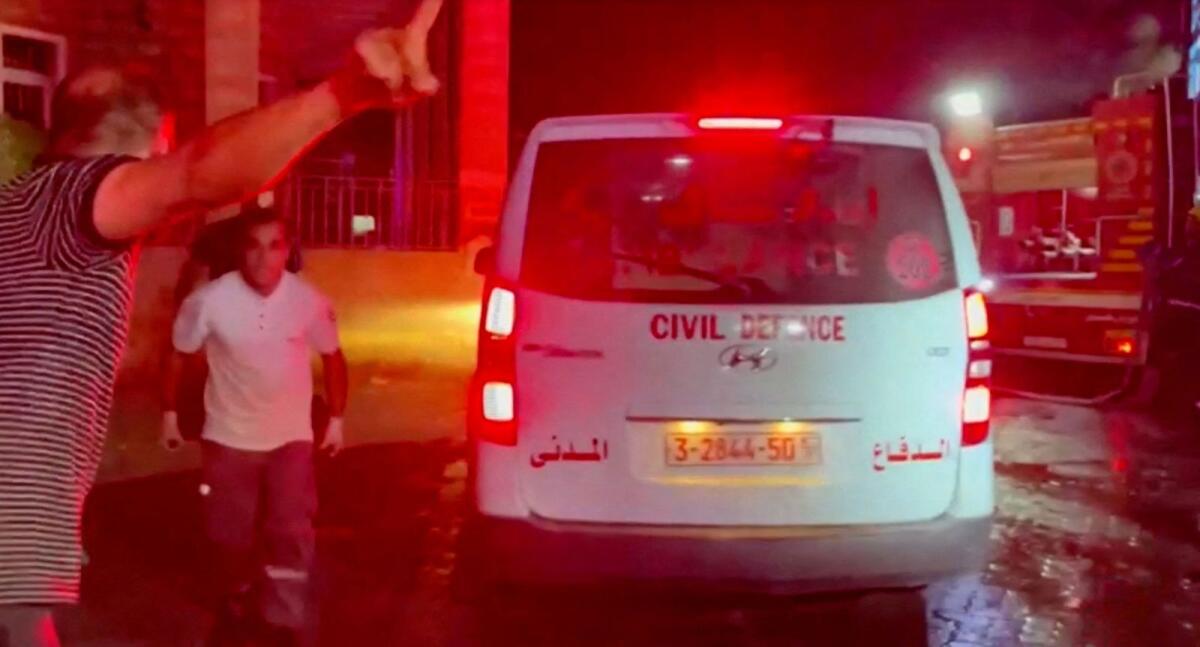 Rescue personnel work at the scene at Al-Ahli Hospital, after hundreds of Palestinians were killed in a blast at Al-Ahli hospital in Gaza that Israeli and Palestinian officials blamed on each other, in Gaza City, Gaza Strip, in this screen grab obtained from video, October 17, 2023.  Photo: Reuters