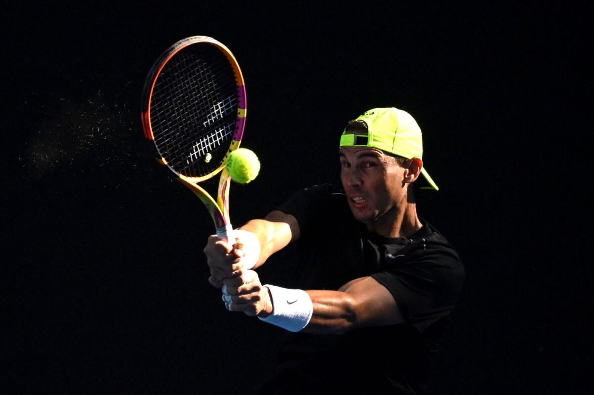 Rafael Nadal hits a return during a practice session at the Australian Open. — AFP file