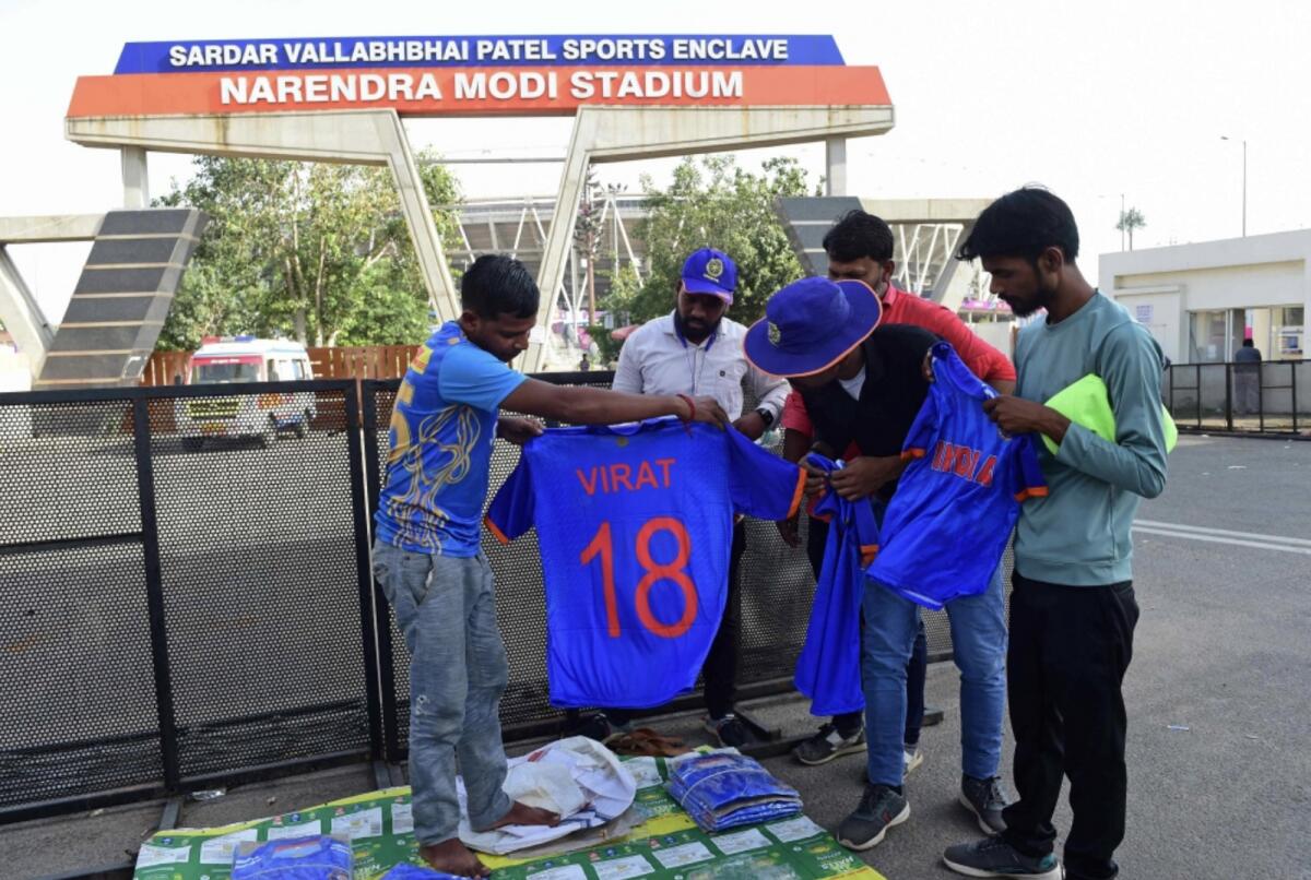 A vendor selling Kohli shirts outside the Narendra Modi Stadium in Ahmedabad. — AFP