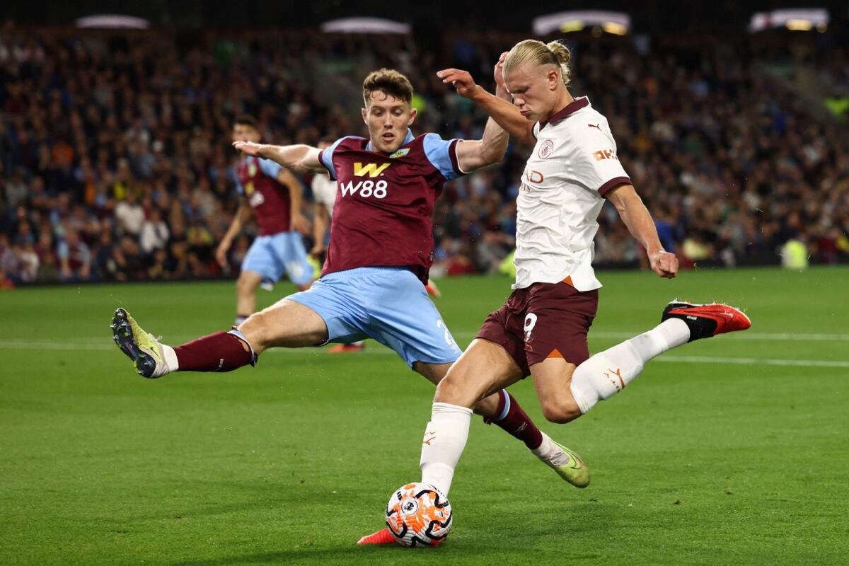 Manchester City's Norwegian striker Erling Haaland (L) fights for the ball with Burnley's Irish defender Dara O'Shea during the English Premier League opener on Friday. - AFP