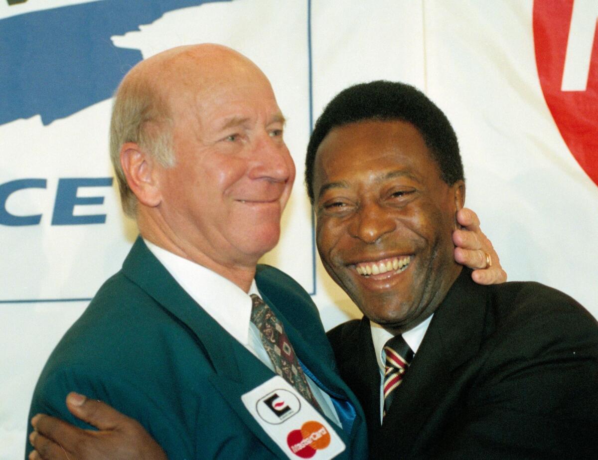 Sir Bobby Charlton with Pele during an event in Paris on February 9, 1995. — AP file