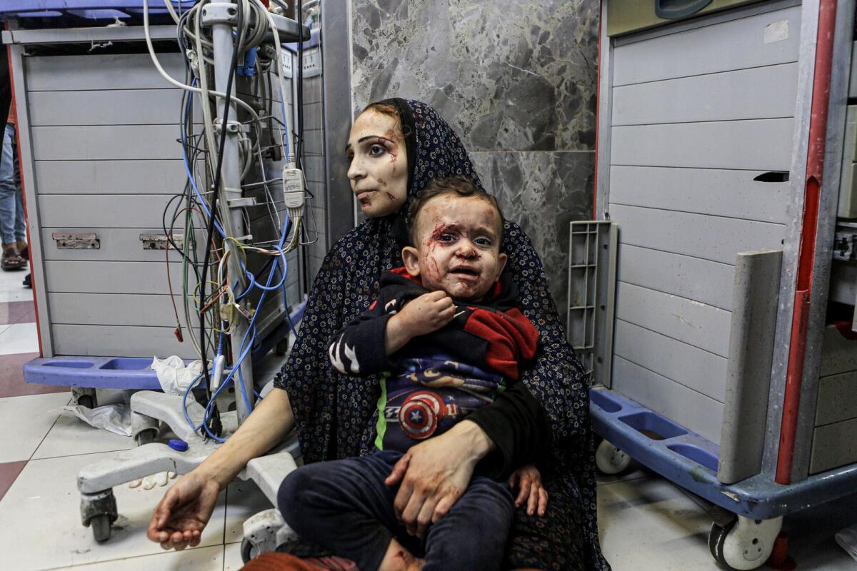 Wounded Palestinians wait for treatment in Al Shifa hospital in Gaza City,. — AP