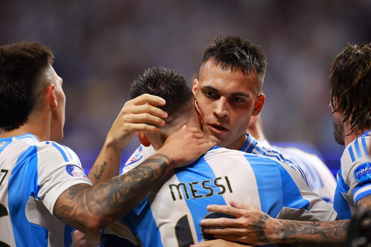 Lautaro Martinez of Argentina celebrates with Lionel Messi after scoring the team's second goal. — AFP