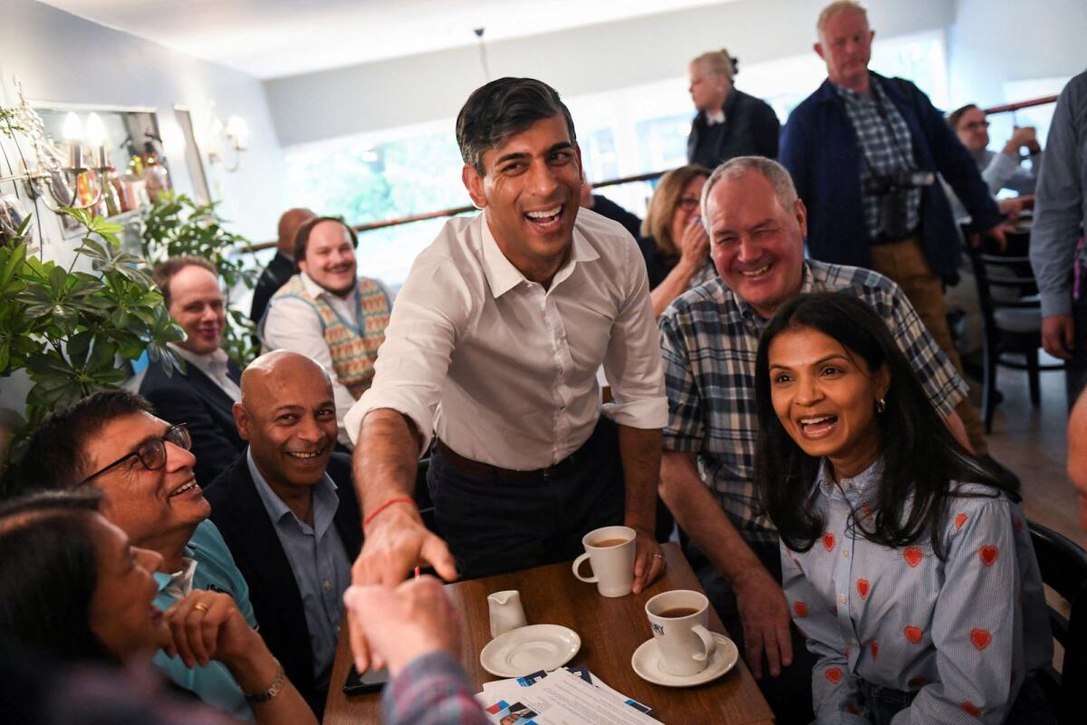 British Prime Minister Rishi Sunak, his wife Akshata Murty and Bob Blackman, Conservative Member of Parliament, attend a Conservative general election campaign event in Stanmore, London, on Sunday. — Reuters