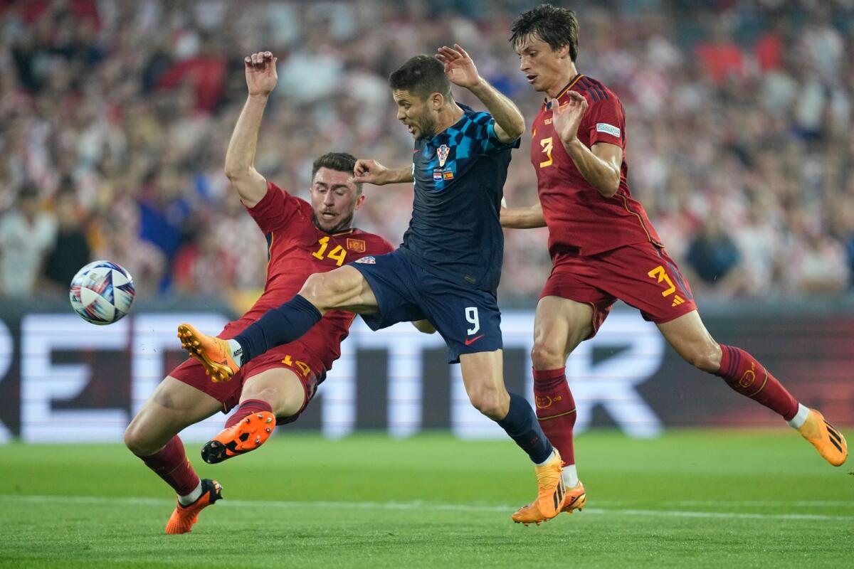 Spain's Aymeric Laporte,(L) clashes with Croatia's Andrej Kramaric (C) during the Nations League final in Jue. - AP File