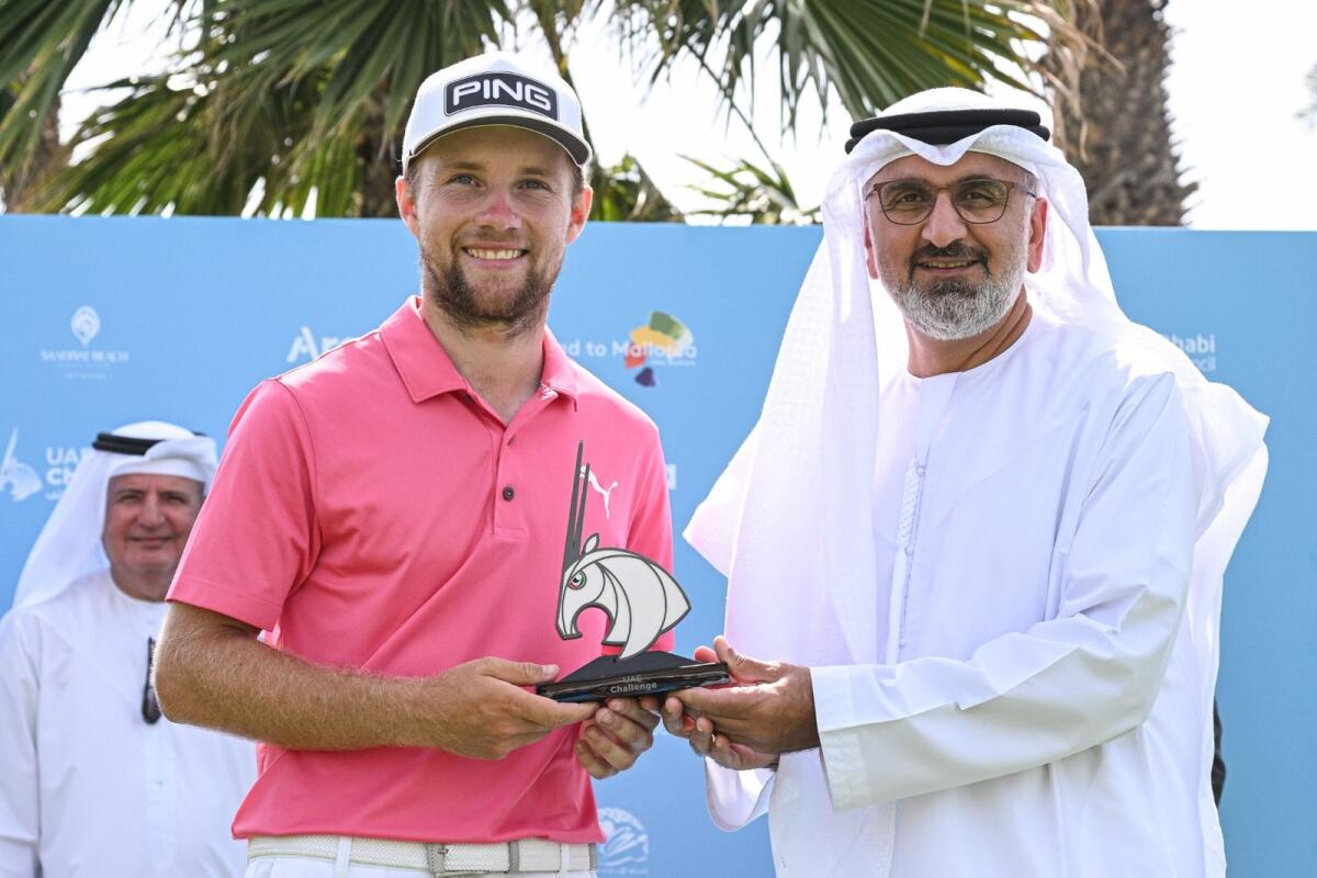 Rasmus Neergaard-Petersen poses with the trophy alongside Aref Hamad Al Awani, General Secretary of the Abu Dhabi Sports Council. - Supplied photo