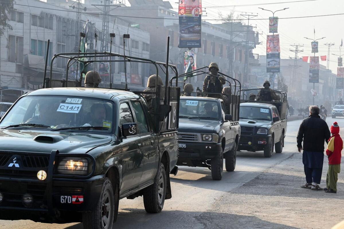 A Pakistan Army convoy patrols along a road in Peshawar on Wednesday, a day prior Pakistan's national elections. — AFP