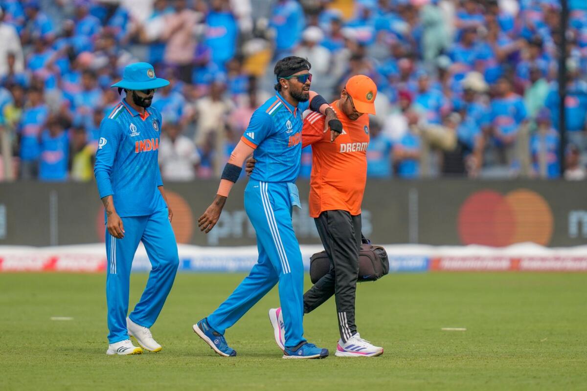 India's Hardik Pandya, center, walks off the field. Photo: AP