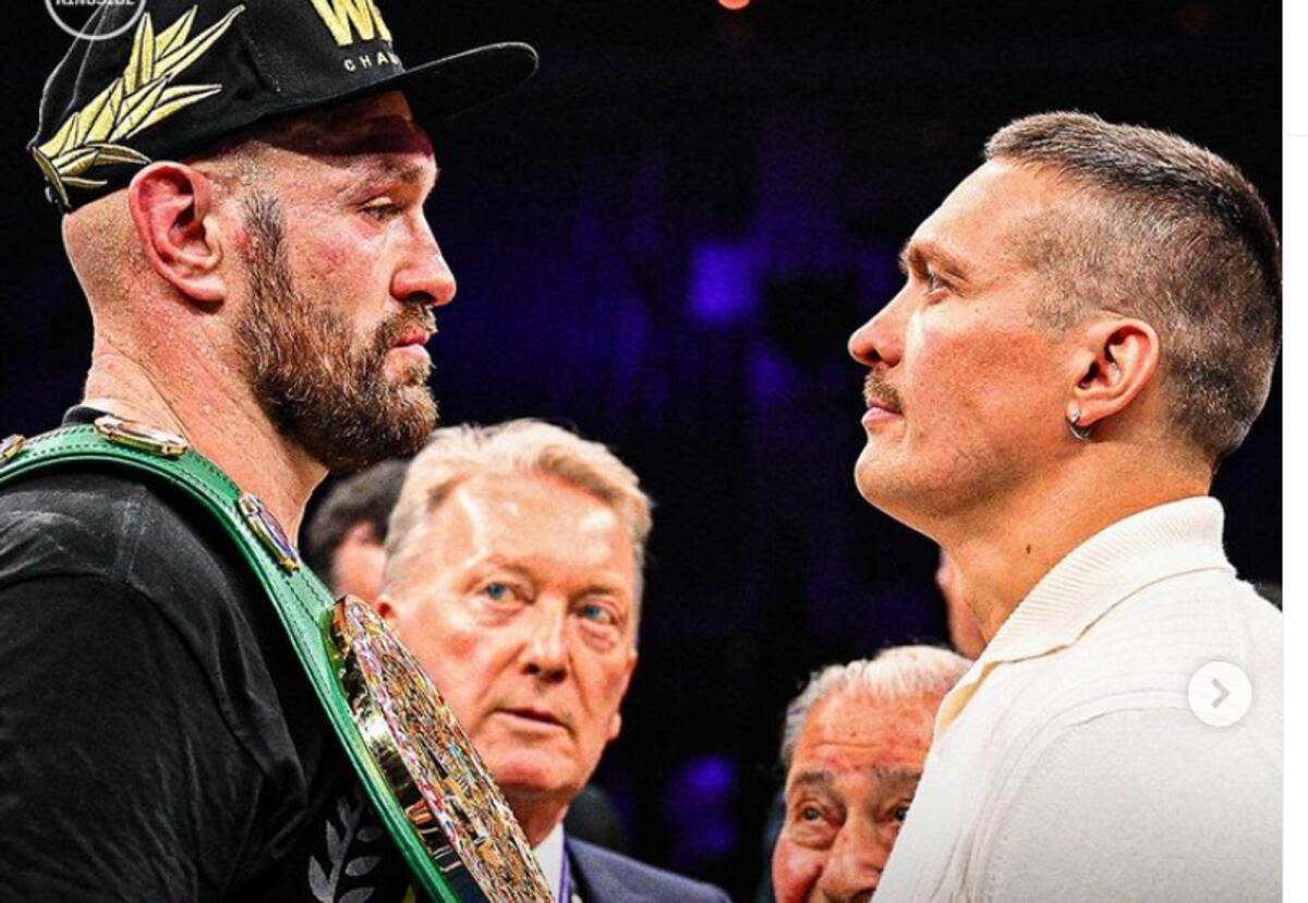 Tyson Fury and and Oleksandr Usyk square off as Hall of Fame boxing promoter Frank Warren looks on . - Instagram