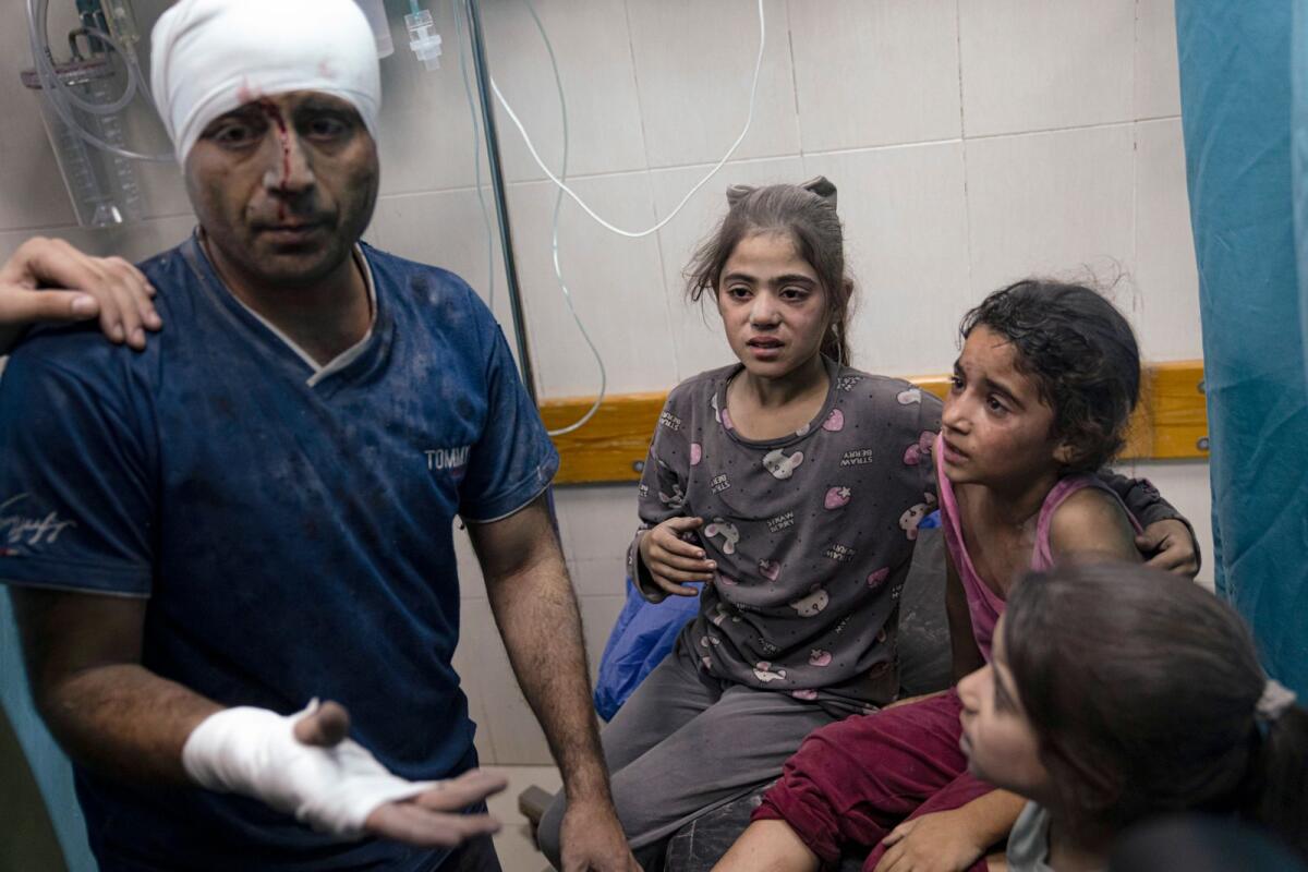Palestinians wounded in the Israeli bombardment of the Gaza Strip for treatment in a hospital in Khan Younis, on Tuesday. — AP