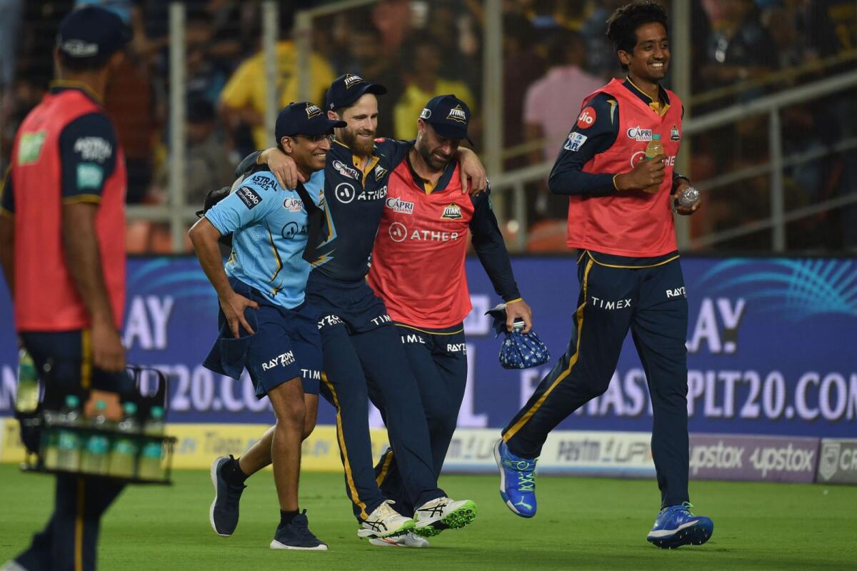 Gujarat Titans' Kane Williamson (centre) is helped by teammates after he was injured during the Indian Premier League match between Gujarat Titans and Chennai Super Kings. — AFP