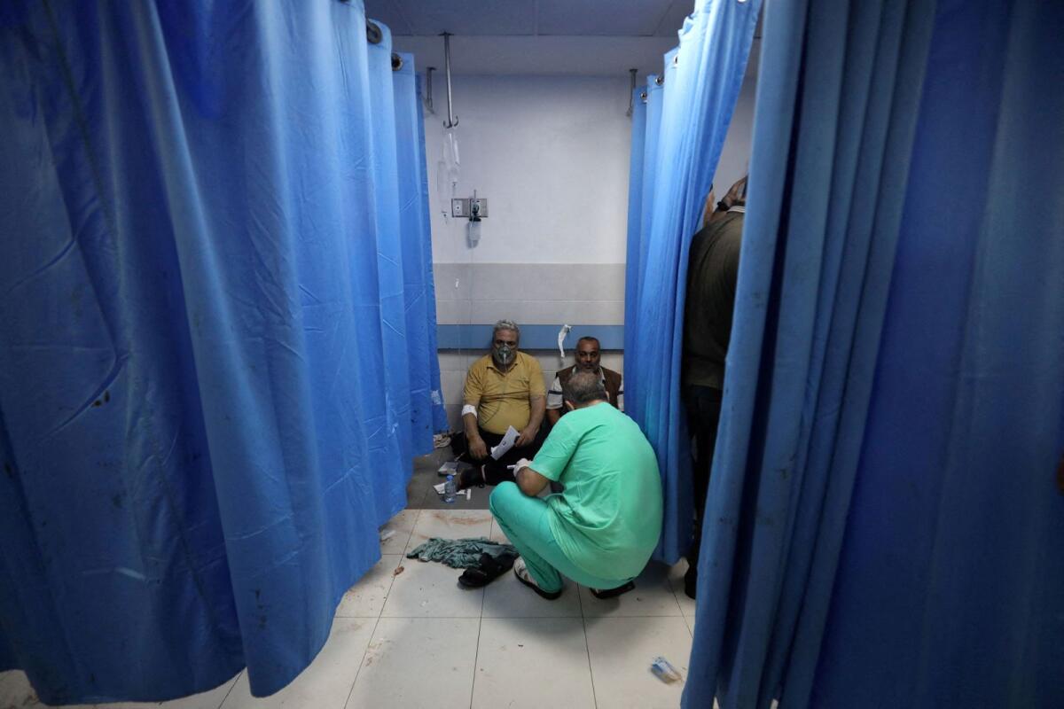 People are assisted at Shifa Hospital after hundreds of Palestinians were killed in a blast at Al-Ahli hospital in Gaza that Israeli and Palestinian officials blamed on each other in Gaza City, Gaza Strip, October 17, 2023. Photo: Reuters