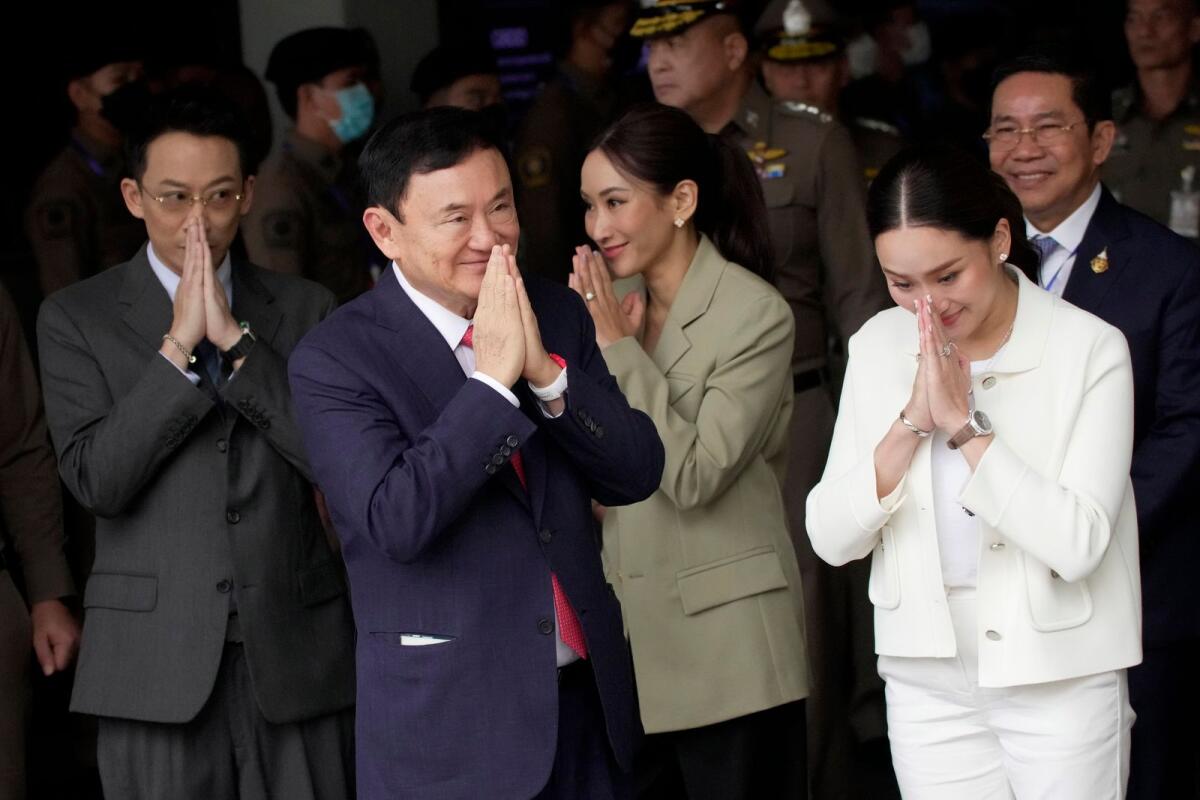 Thailand's former prime minister Thaksin Shinawatra, foreground, with, from left, his son Phantongtae, his daughters Pinthongta and Paetongtarn, arrives at Don Muang airport in Bangkok, Thailand, on Aug. 22, 2023. -- AP file
