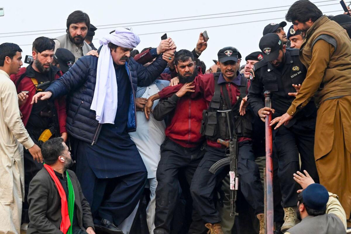 Former prime minister Imran Khan's Pakistan Tehreek-e-Insaf (PTI) party nominated Chief Minister of Khyber Pakhtunkhwa Ali Amin Gandapur (4L) protests against the alleged skewing in Pakistan's national election results, in Peshawar on February 17, 2024. AFP