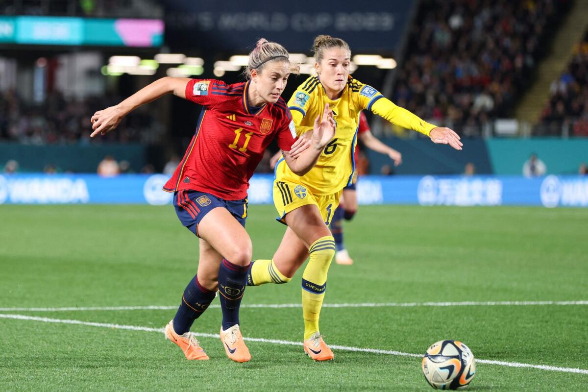 Spain's Alexia Putellas fights for the ball with  Sweden's Filippa Angeldahl during the semi-final. - AFP