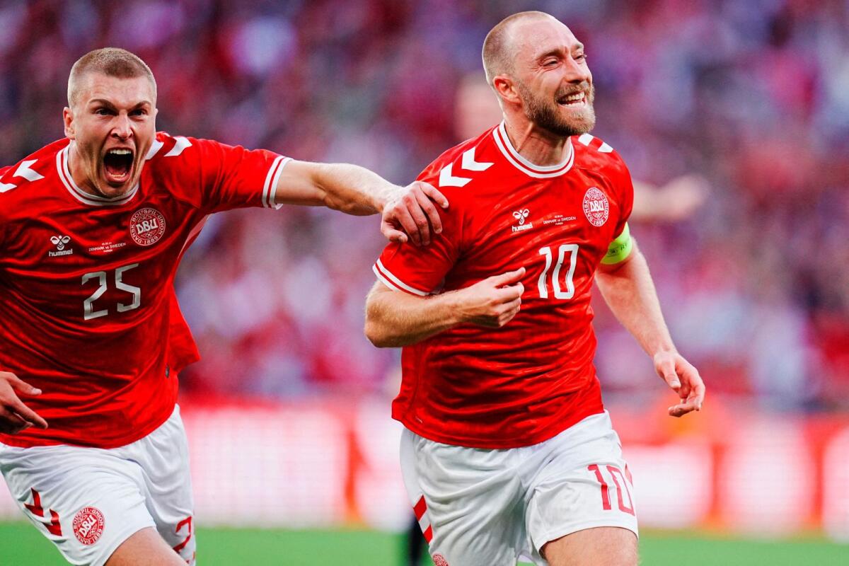 Denmark's Christian Eriksen (right) celebrates scoring their second goal. — Reuters