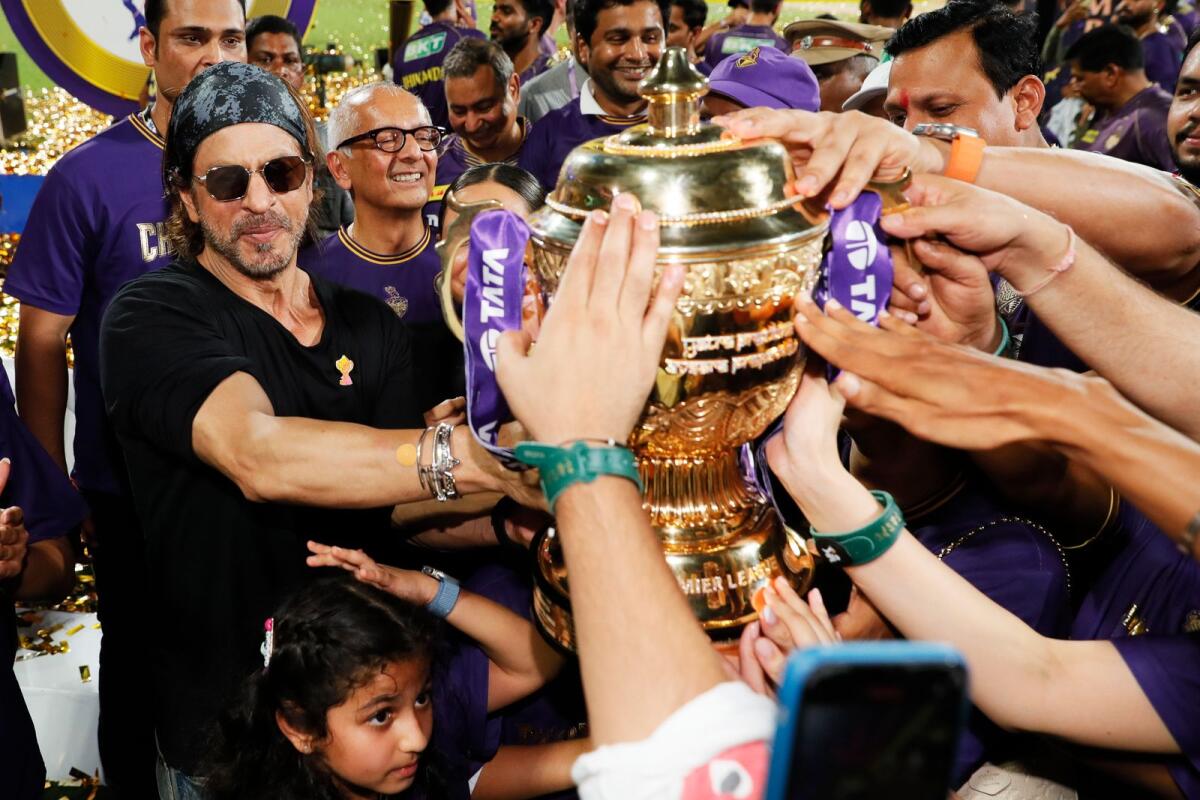 Shah Rukh Khan, co-owner of team Kolkata Knight Riders, celebrates with the trophy. — IPL