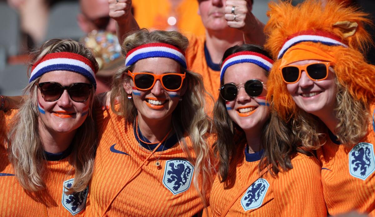 Netherlands fans pose before the start of the match against Austria at the Olympiastadion in Berlin. — AFP