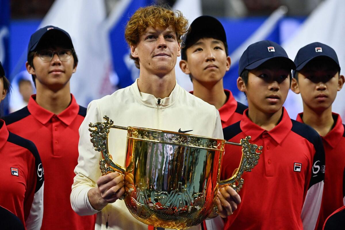 Italy's Jannik Sinner (second left) holds the trophy after defeating Russia's Daniil Medvedev. — AFP