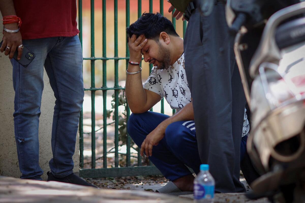 Vinod Kumar cries outside a hospital morgue. Photo: Reuters