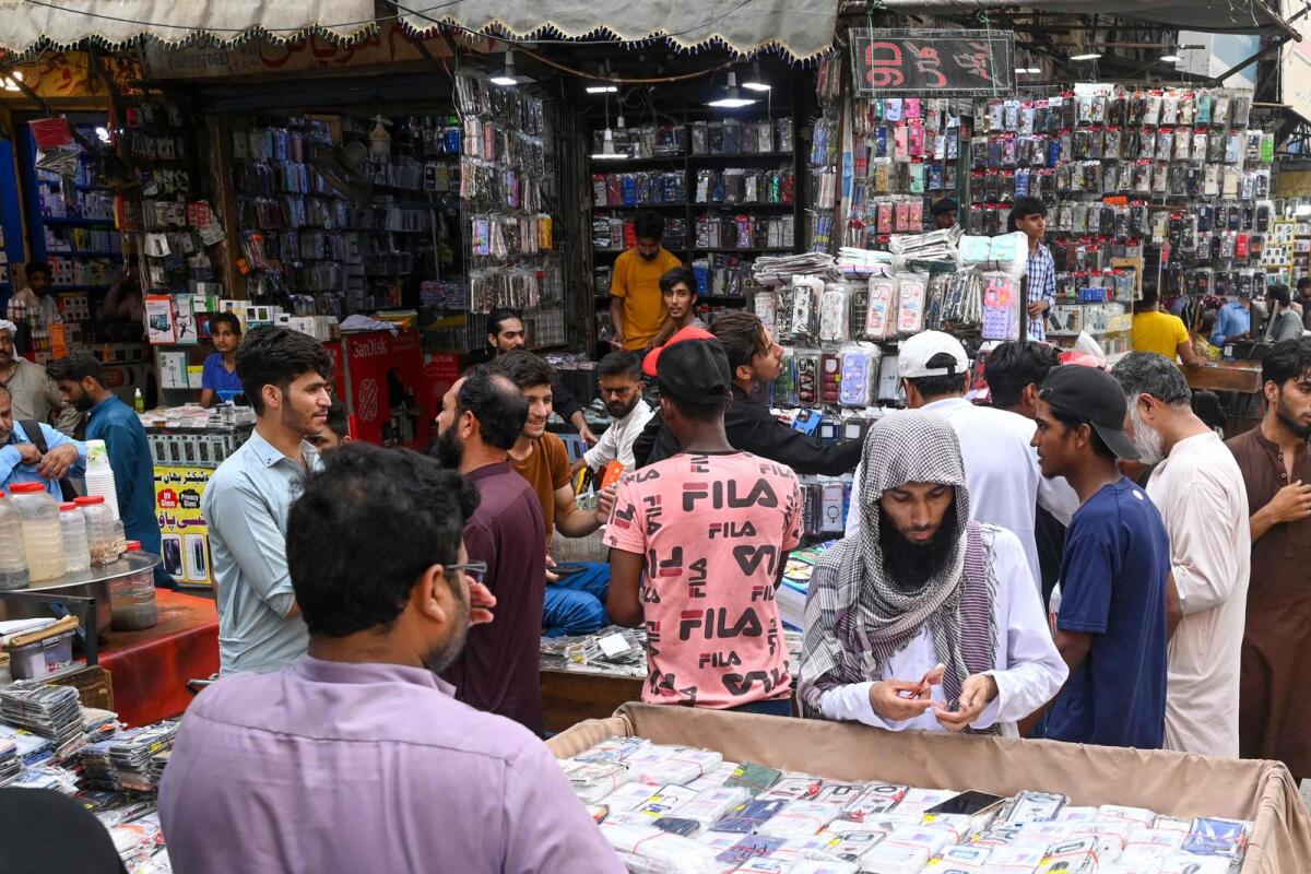Shopkeepers sell accessories at a mobile market in Lahore on Thursday.  — AFP