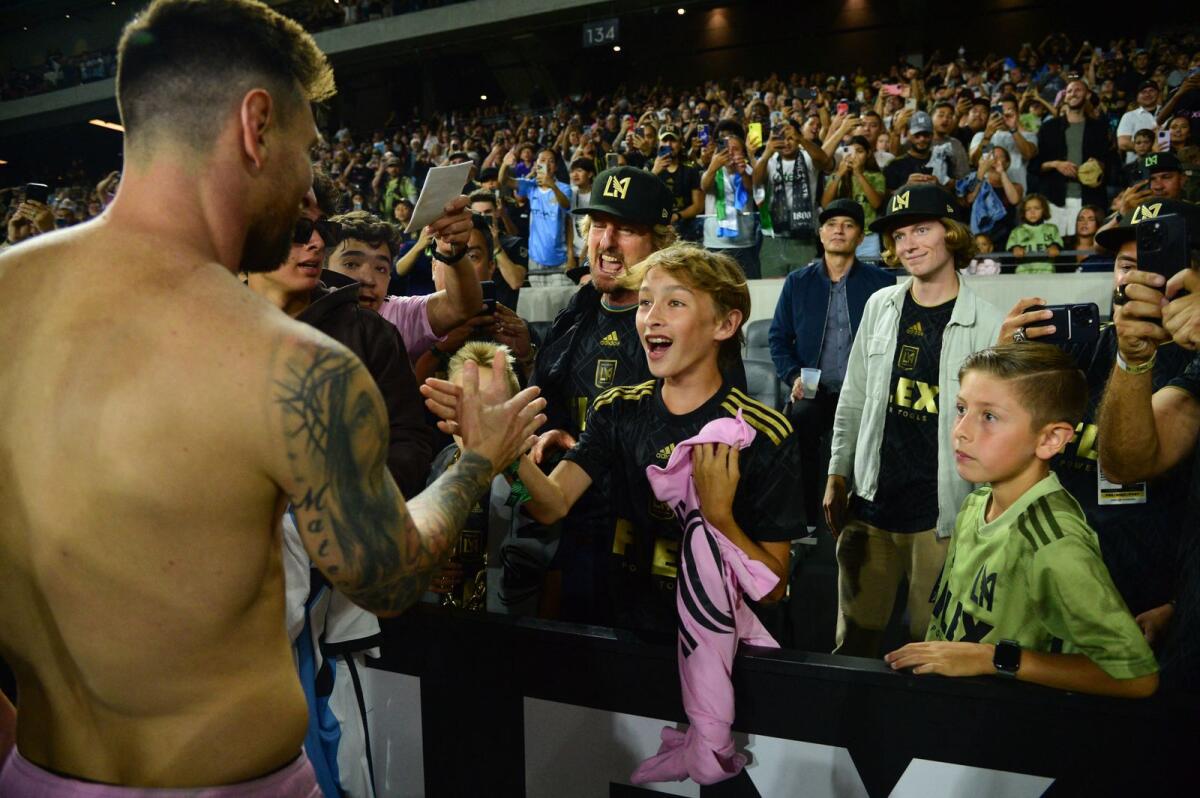 Inter Miami forward Lionel Messi greets actor Owen Wilson's children after the match. — Reuters
