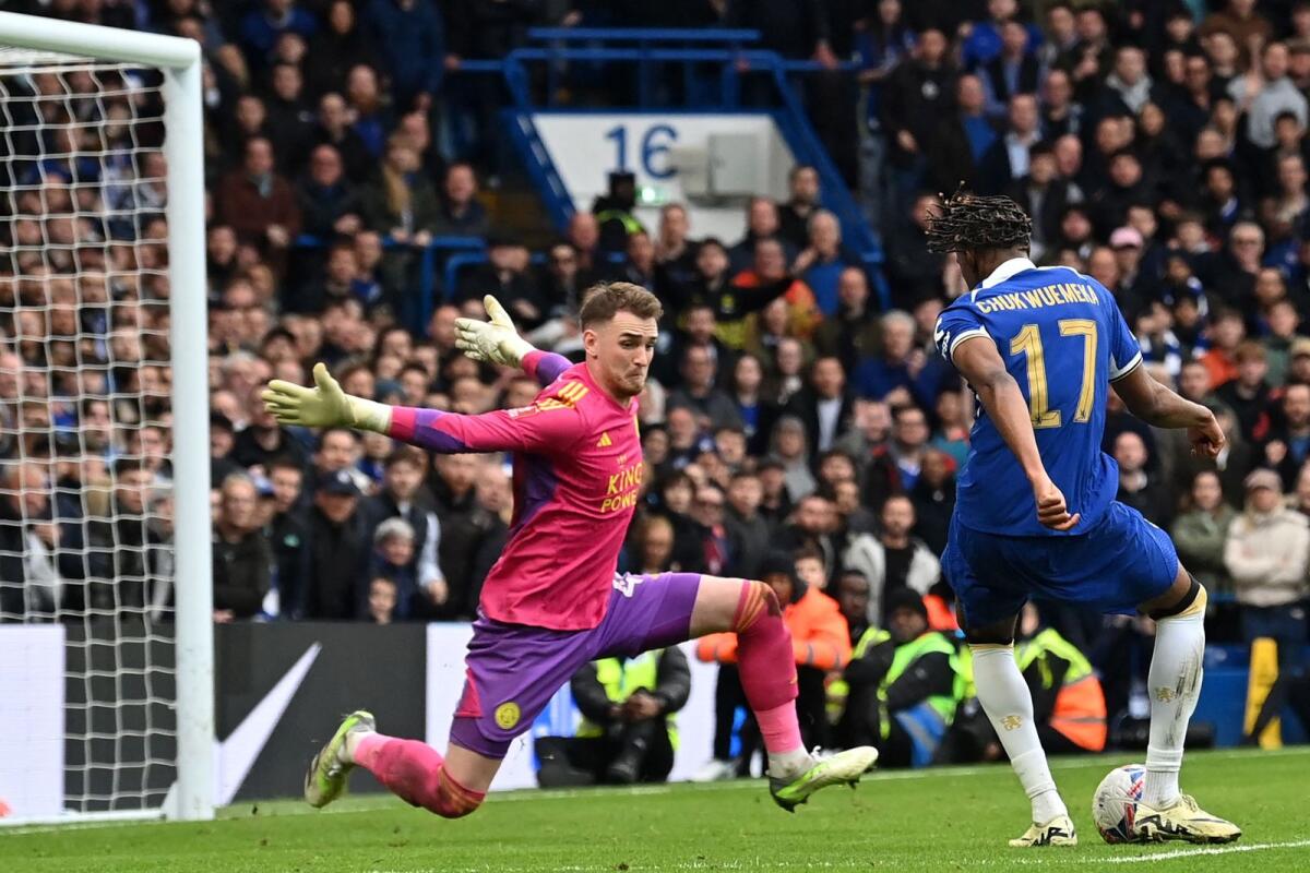 Chelsea's Carney Chukwuemeka (right) scores the team's third goal against Leicester City goalkeeper Jakub Stolarczyk. — AFP