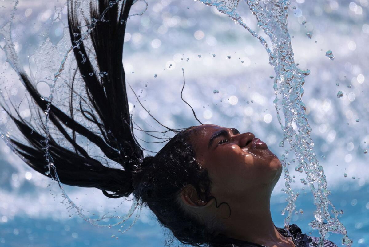 An Egyptian girl whips her wet hair while cooling off in the water amid a heatwave at a Red Sea resort in Hurghada, Egypt, on July 25, 2023. — Reuters