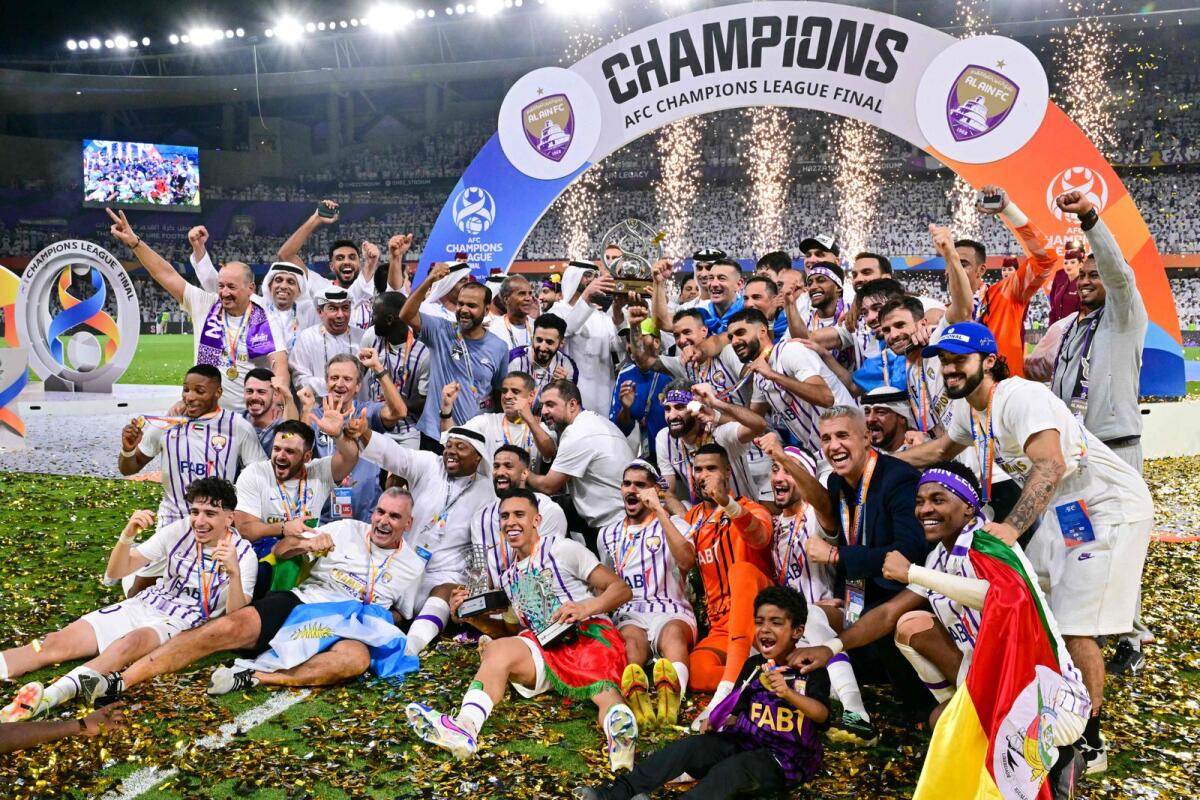 Al Ain's players celebrate with the winner's trophy after the second leg of the AFC Champions League Final against Japan's Yokohama F. Marinos at the Hazza Bin Zayed Stadium. - AFP