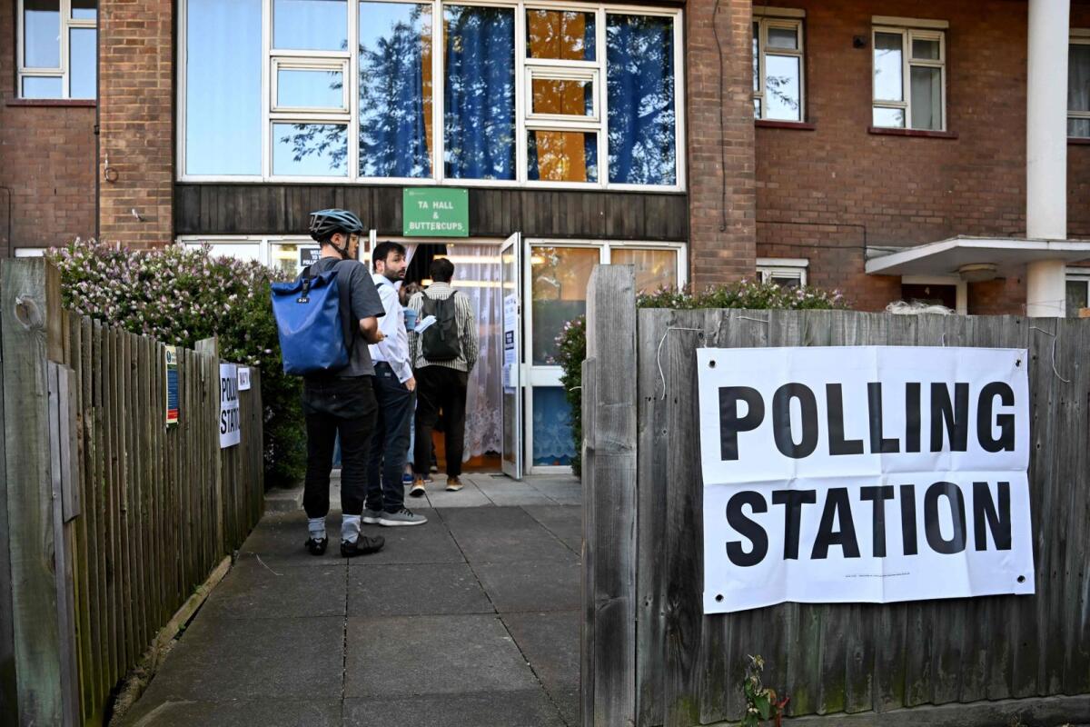 People queue to vote at a polling station in London on Thursday -- AFP