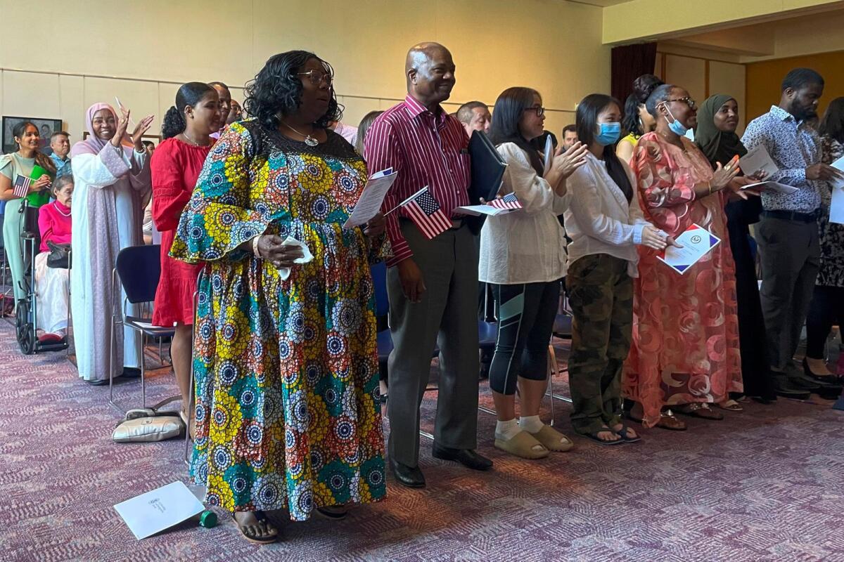 Dozens of people become US citizens during a naturalisation ceremony at Mount Zion Temple in St. Paul, Minn., on June 21, 2023. -- AP