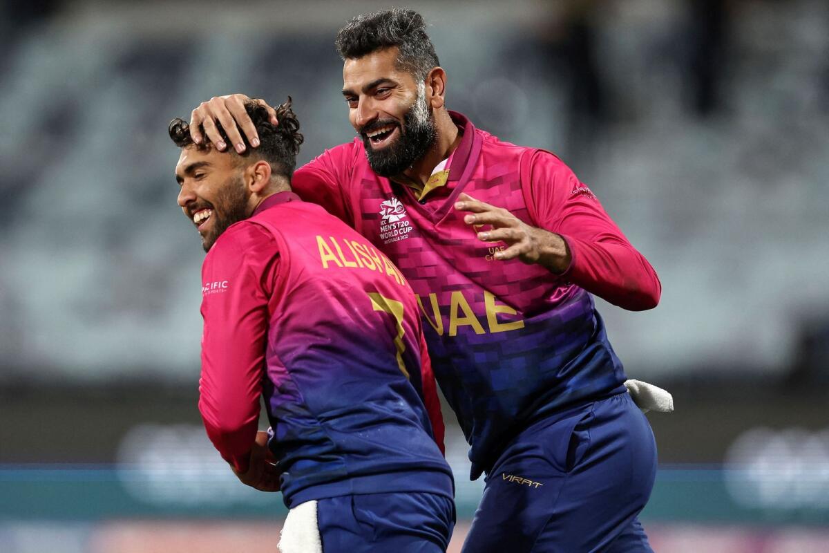 UAE's Alishan Sharafu (left) and Ahmed Raza celebrate the wicket of Namibia's David Wiese. (AFP)
