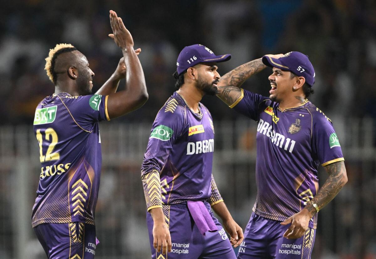 Kolkata Knight Riders' Andre Russell (L) celebrates with Shreyas Iyer (C) and Sunil Narine after taking the wicket of Mumbai Indians' Suryakumar Yadav during the Indian Premier League. - AFP